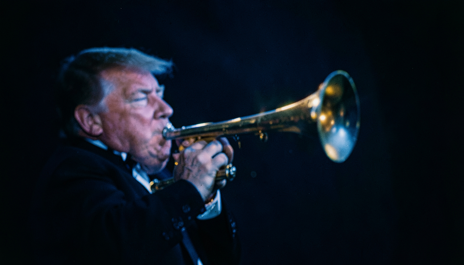 Trumpet bell catching a gleam of light against a rich charcoal and midnight-blue backdrop